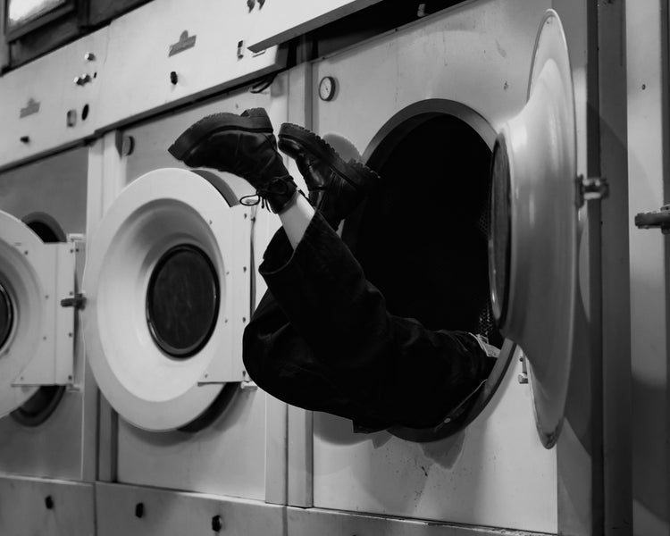 Person is stuck upside down in a washing machine.